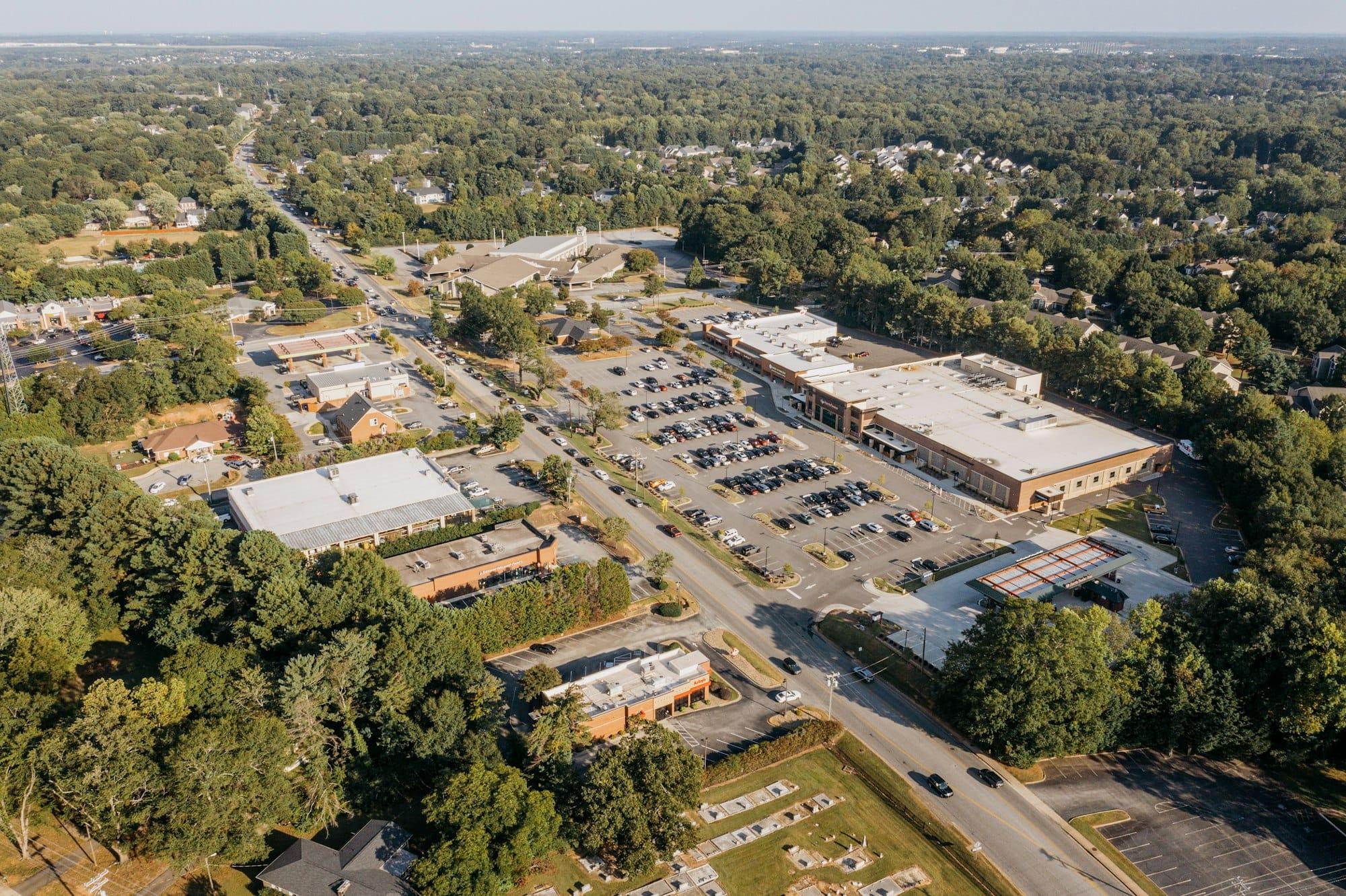 Sunlit neighborhood strip mall with mixed retail tenants