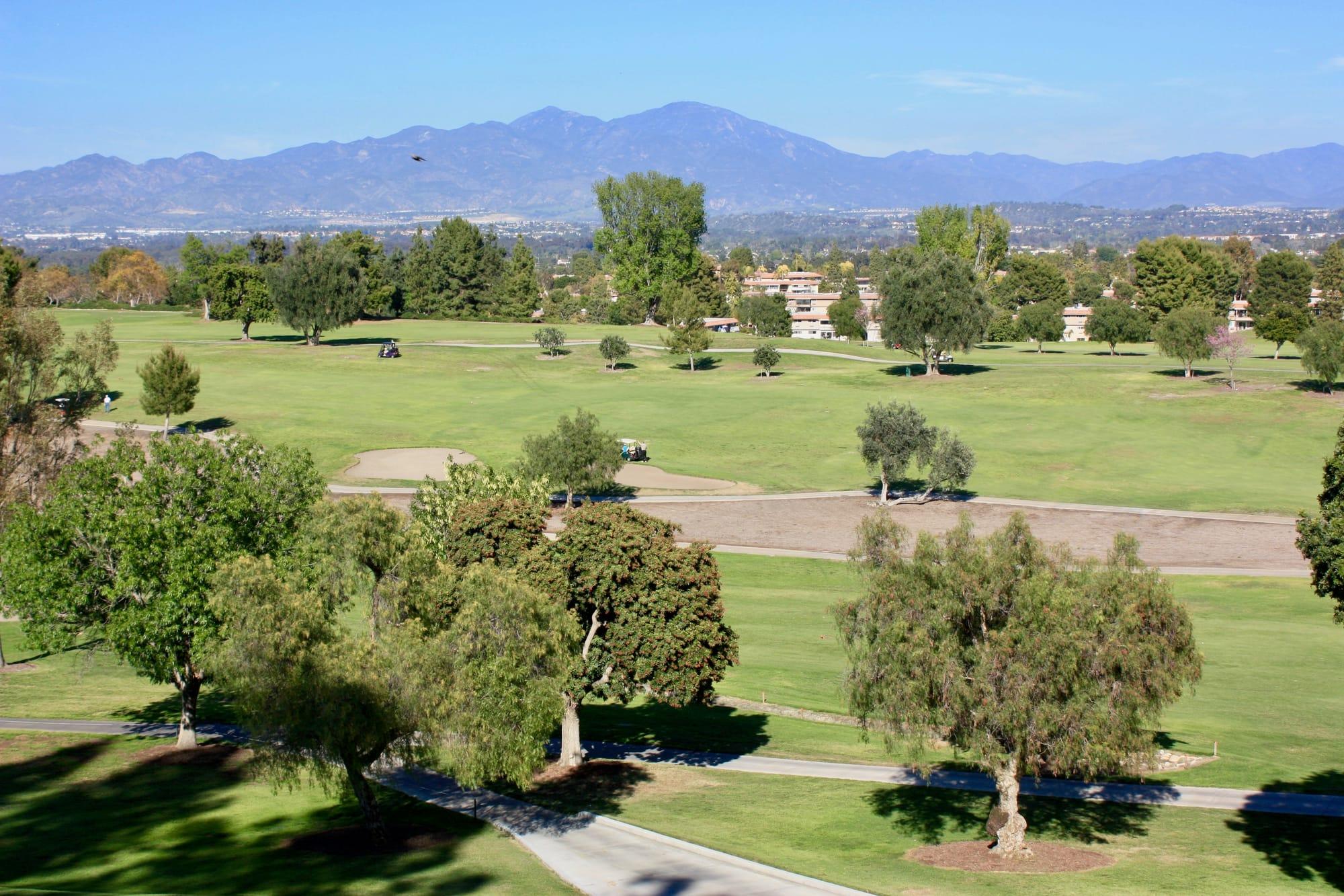 Elevated view of the Laguna Woods Village golf course, residences, and Saddleback foothills