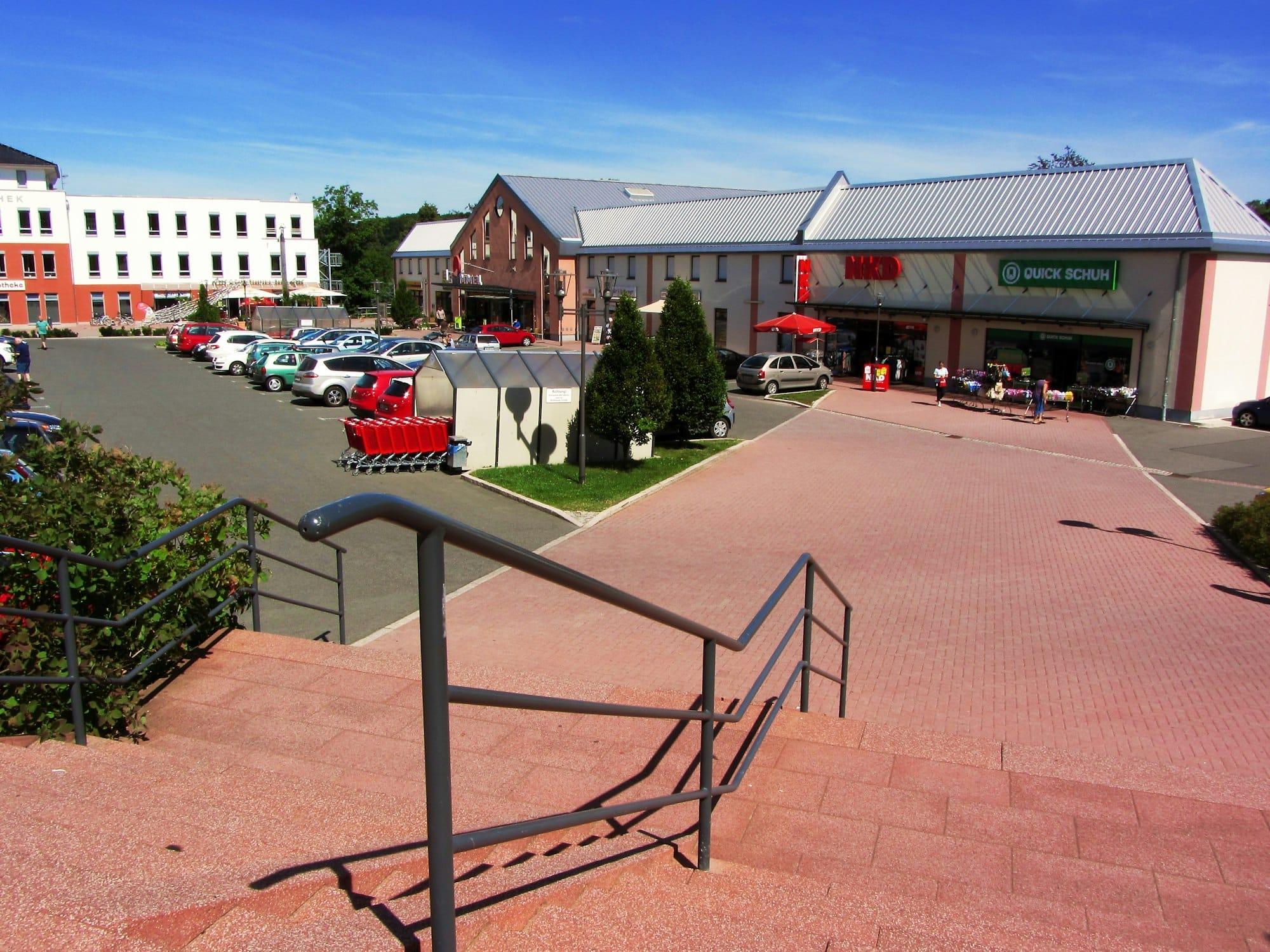 Multi-tenant commercial plaza exterior at golden hour